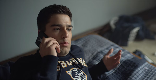 a football jock on the phone in bed